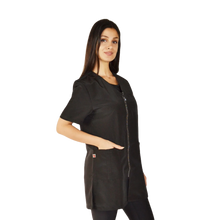 Load image into Gallery viewer, Woman wearing a black scrub top on a white background

Pet groomer jacket
Water resistant grooming jacket

Hair repellent jacket
Bleach resistant jacket
Chemical proof jacket
Zippered pocket jacket
Durable grooming apparel
Professional grooming smock
Ladybird Line apparel
Grooming uniforms NZ